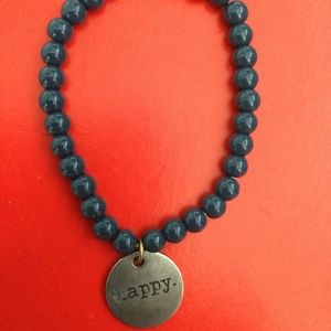 Blue beaded bracelet with happy tag